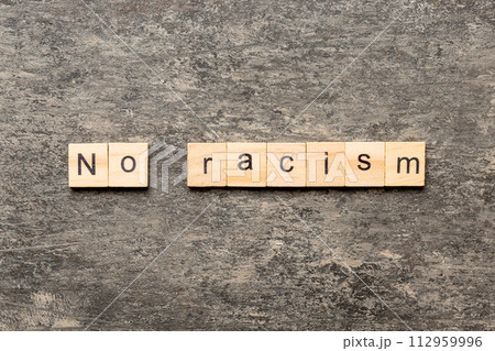 No racism word written on wood block. No racism text on table, concept No racism word written on wood block. No racism text on table, concept 112959996