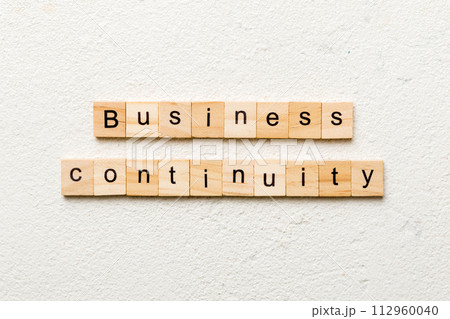 Business Continuity word written on wood block. Business Continuity text on cement table for your desing, concept 112960040
