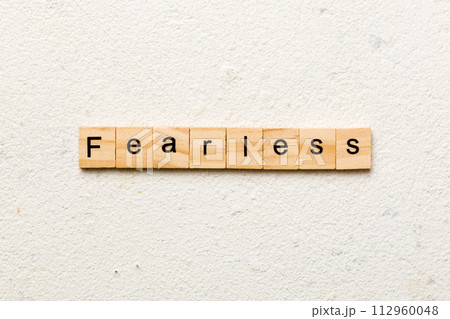 Fearless word written on wood block. Fearless text on cement table for your desing, concept 112960048