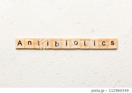 antibiotic word written on wood block. antibiotic text on table, concept 112960349
