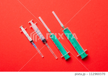 Top view of medical syringes on colorful background. Health care concept with copy space 112960370