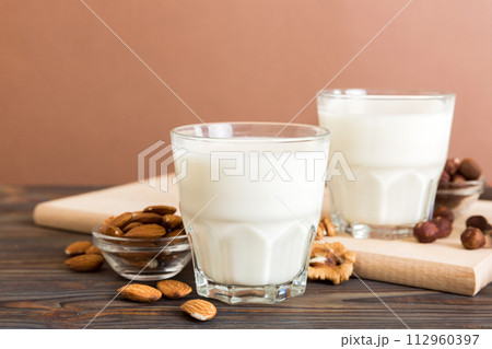 Set or collection of various vegan milk almond, cashew, on table background. Vegan plant based milk and ingredients, top view Set or collection of various vegan milk almond, cashew, on table background. Vegan plant based milk and ingredients, top view 112960397