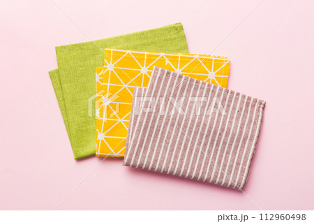 top view with red empty kitchen napkin isolated on table background. Folded cloth for mockup with copy space, Flat lay. Minimal style top view with red empty kitchen napkin isolated on table background. Folded cloth for mockup with copy space, Flat lay. Minimal style 112960498