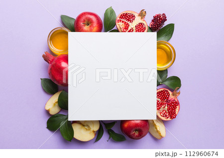 Flat lay composition with Blank flyer poster and symbols jewish Rosh Hashanah holiday attributes on colored background, New Year holiday Traditional. Top view with copy space mock up 112960674