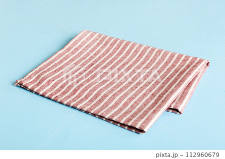 top view with red empty kitchen napkin isolated on table background. Folded cloth for mockup with copy space, Flat lay. Minimal style top view with red empty kitchen napkin isolated on table background. Folded cloth for mockup with copy space, Flat lay. Minimal style 112960679