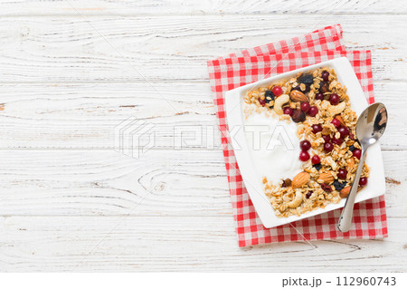 Healthy breakfast food with granola, yogurt, fruits and nuts. Dessert parfait with dried fruits for breakfast Healthy breakfast food with granola, yogurt, fruits and nuts. Dessert parfait with dried fruits for breakfast 112960743