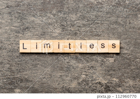 Limitless word written on wood block. Limitless text on cement table for your desing, concept 112960770