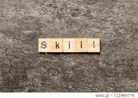 Skill word written on wood block. Skill text on cement table for your desing, concept 112960776