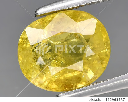 natural yellow grossular garnet gemstone on the background 112963587