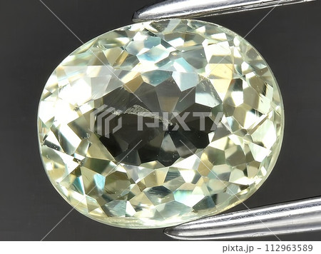 natural yellow grossular garnet gemstone on the background 112963589