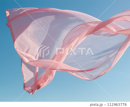 Flying pink fabric wave on blue sky background and illuminated by sunlight 112963776