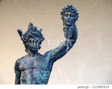 Detail of Perseus holding head of Medusa, bronze statue in Loggia de Lanzi, Piazza della Signoria, Florence, Italy. Isolated on white Detail of Perseus holding head of Medusa, bronze statue in Loggia de Lanzi, Piazza della Signoria, Florence, Italy. Isolated on white 112965024