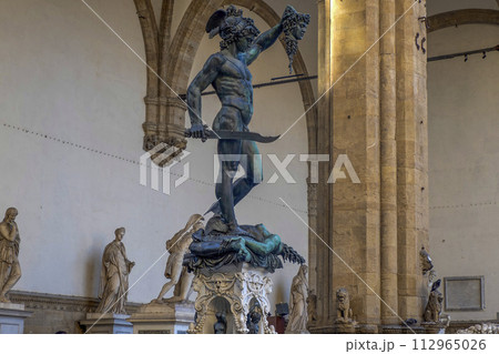 Detail of Perseus holding head of Medusa, bronze statue in Loggia de Lanzi, Piazza della Signoria, Florence, Italy. Isolated on white 112965026