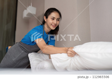 A woman asian staff cleaning service, tool and bucket for work. a young female cleaner with products to clean a bedroom 112965506