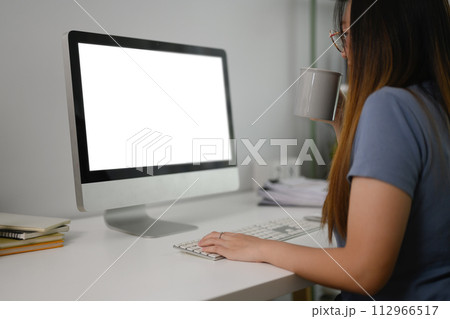 Young Asian woman freelancer working on computer on table at home office Young Asian woman freelancer working on computer on table at home office 112966517