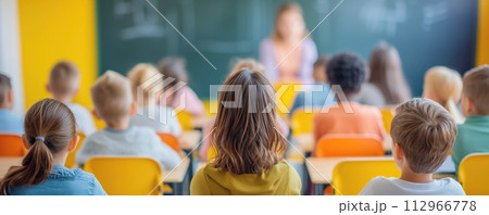 Children sitting at the classroom and studying. 112966778