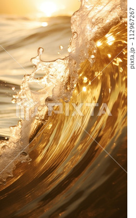 Beautiful gold wave in the ocean. Water surface in the golden light of the sun at sunset or dawn. Surfer's POV 112967267