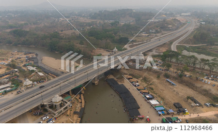 Aerial view of local Thai peoples visiting Kok river during Songkran festival in Chiang Rai province, Thailand. Aerial view of local Thai peoples visiting Kok river during Songkran festival in Chiang Rai province, Thailand. 112968466