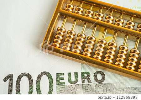 Gold abacus on Euro banknote money, economy finance exchange trade investment concept. 112968895