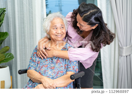 Caregiver help Asian senior woman on wheelchair with love at home. Caregiver help Asian senior woman on wheelchair with love at home. 112968897