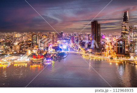 Aerial panoramic cityscape view of HoChiMinh city and the River Saigon, Vietnam with blue sky at sunset. View from Thu Thiem peninsula Aerial panoramic cityscape view of HoChiMinh city and the River Saigon, Vietnam with blue sky at sunset. View from Thu Thiem peninsula 112968935