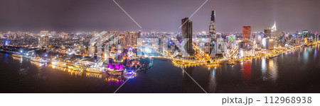 Aerial panoramic cityscape view of HoChiMinh city and the River Saigon, Vietnam with blue sky at sunset. View from Thu Thiem peninsula Aerial panoramic cityscape view of HoChiMinh city and the River Saigon, Vietnam with blue sky at sunset. View from Thu Thiem peninsula 112968938