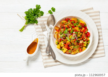 spanish potato salad with chorizo in white bowl spanish potato salad with chorizo in white bowl 112968957