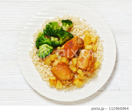 chicken thighs with pineapple, rice and broccoli 112968964