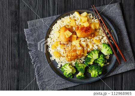 chicken thighs with pineapple, rice and broccoli 112968965