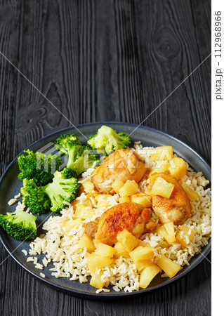 chicken thighs with pineapple, rice and broccoli 112968966