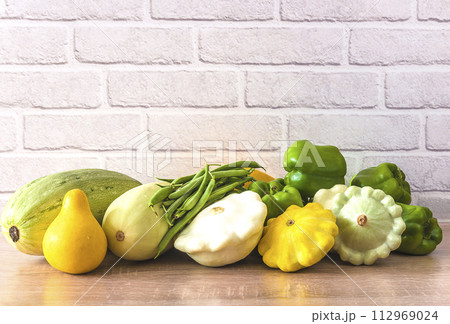 Fresh vegetables (zucchnini, cabbage, bell pepper, green beans) on a kitchen table 112969024