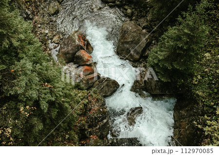 Wild river waterfall in mountain forest 112970085