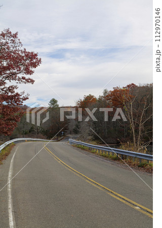 On a sunny cloudy day, the road along the lake in Upstate New York. 112970146
