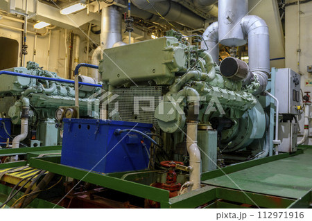 Marine engine. Diesel generator. Engine room interior. 112971916