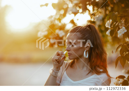 stylish female in white shirt using nasal spray stylish female in white shirt using nasal spray 112972336