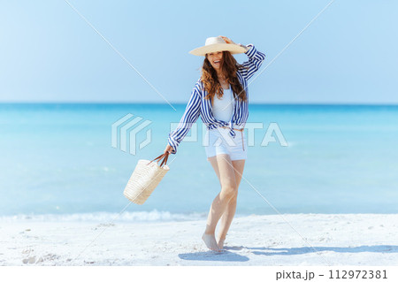 happy elegant woman on beach having fun time 112972381
