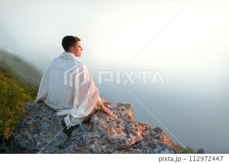 Young man sit on the hill 112972447