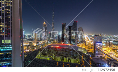 Dubai downtown skyline night timelapse with tallest building and Sheikh Zayed road traffic, UAE Dubai downtown skyline night timelapse with tallest building and Sheikh Zayed road traffic, UAE 112972456