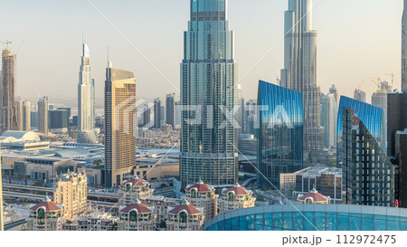 Dubai downtown skyline at sunset timelapse with tallest building and Sheikh Zayed road traffic, UAE Dubai downtown skyline at sunset timelapse with tallest building and Sheikh Zayed road traffic, UAE 112972475