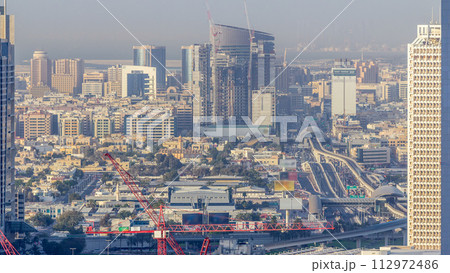 Skyline view of the buildings of Sheikh Zayed Road and DIFC timelapse in Dubai, UAE. Skyline view of the buildings of Sheikh Zayed Road and DIFC timelapse in Dubai, UAE. 112972486