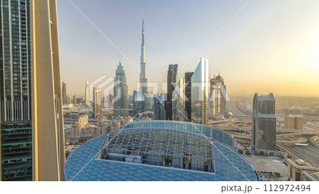Dubai downtown skyline at sunset timelapse with tallest building and Sheikh Zayed road traffic, UAE 112972494