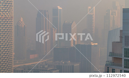 Foggy morning in downtown of Dubai timelapse. 112972540