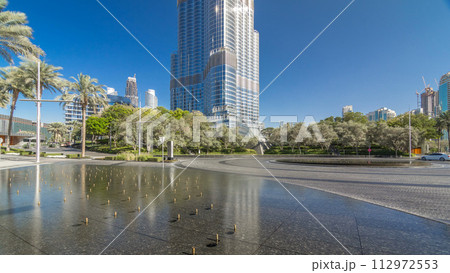 Fountains near main entrance to the tallest skyscraper timelapse hyperlapse, Dubai 112972553