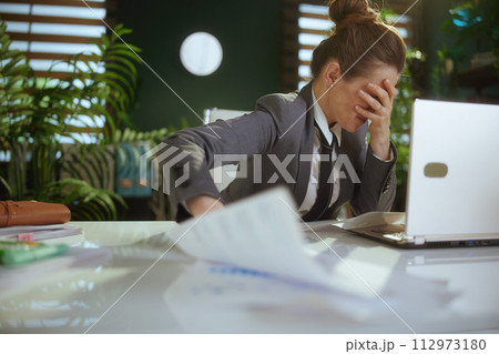 sad woman worker in green office throwing documents sad woman worker in green office throwing documents 112973180