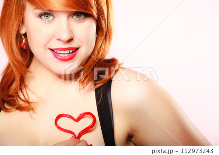 Girl holding valentine red heart love symbol. Valentines day. 112973243