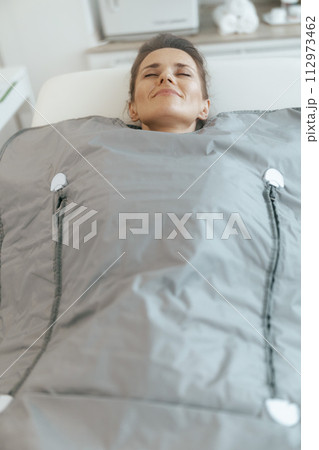 woman doing whiskey swaddling procedure in thermal blanket woman doing whiskey swaddling procedure in thermal blanket 112973462
