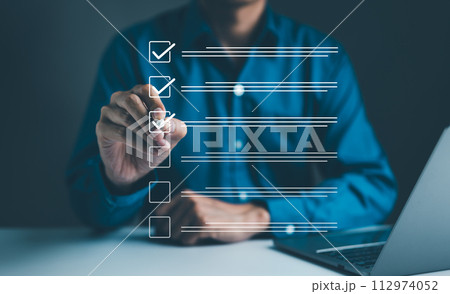 Businessman using pen to tick correct sign mark in checkbox for quality document control checklist and business approve project concept. Check mark, Filling out digital form checklist, Online exam, Businessman using pen to tick correct sign mark in checkbox for quality document control checklist and business approve project concept. Check mark, Filling out digital form checklist, Online exam, 112974052
