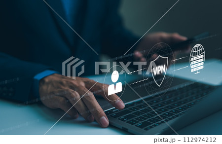 Virtual private network encryption connection concept. Using VPN for secure internet access. A businessman securely accesses the internet through a VPN on his laptop, with a digital interface overlay. 112974212