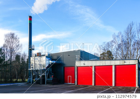 New modern wood chip biofuel boiler house for increased heat energy production efficiency in action New modern wood chip biofuel boiler house for increased heat energy production efficiency in action 112974579