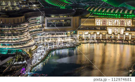 Night aerial view Dancing fountains downtown and in a man-made lake timelapse in Dubai, UAE. 112974681